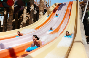 People sliding down a water slide