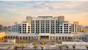 An overview of the Hilton Hotel, Abu Dhabi with a beachfront with modern architecture and palm-lined surroundings