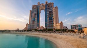 Beachfront view of Rixos Marina, highlighting its striking architectural structure against the blue sky. 